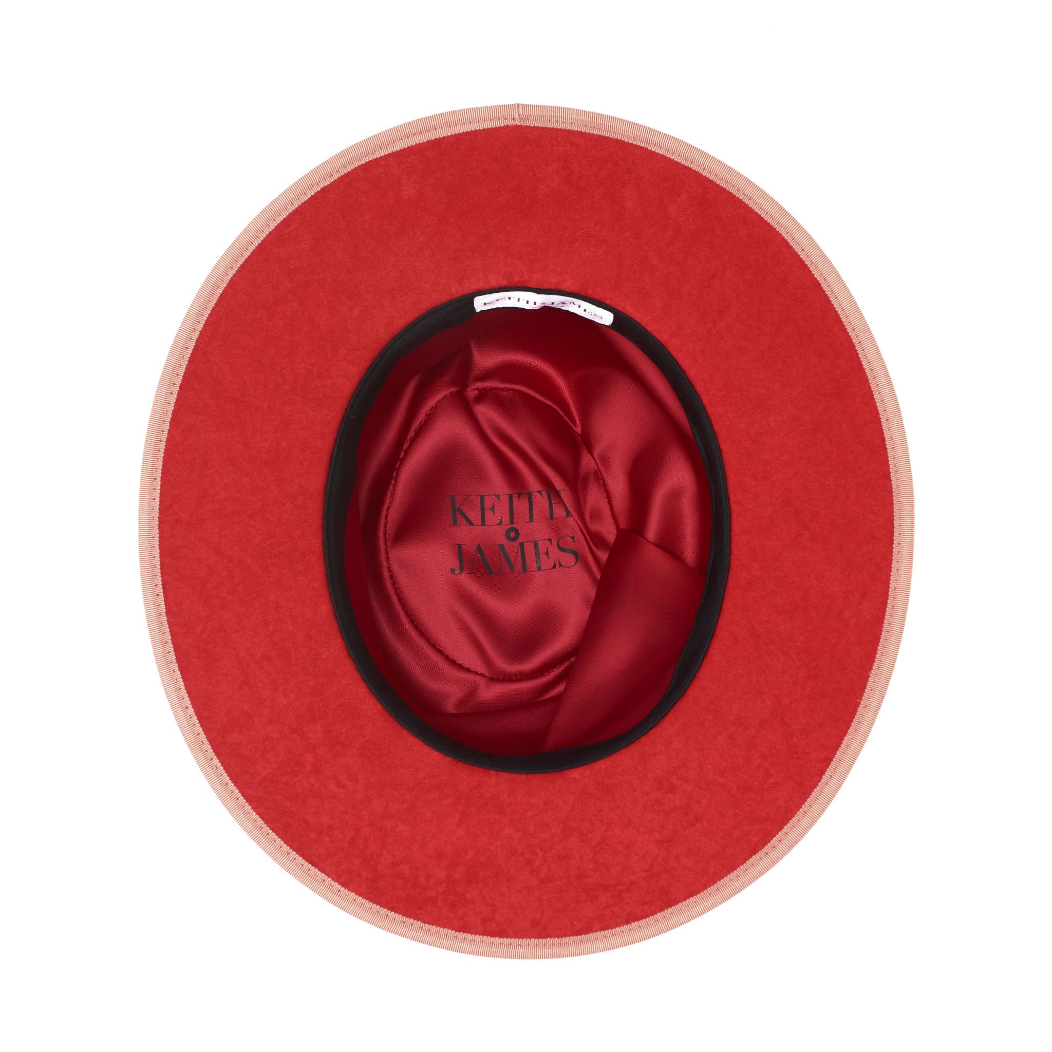 Pink straw hat with a band and button on a white background