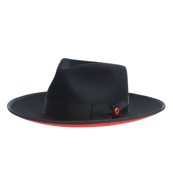 A classic black hat with a red bottom brim and a signature logo pin on the side.