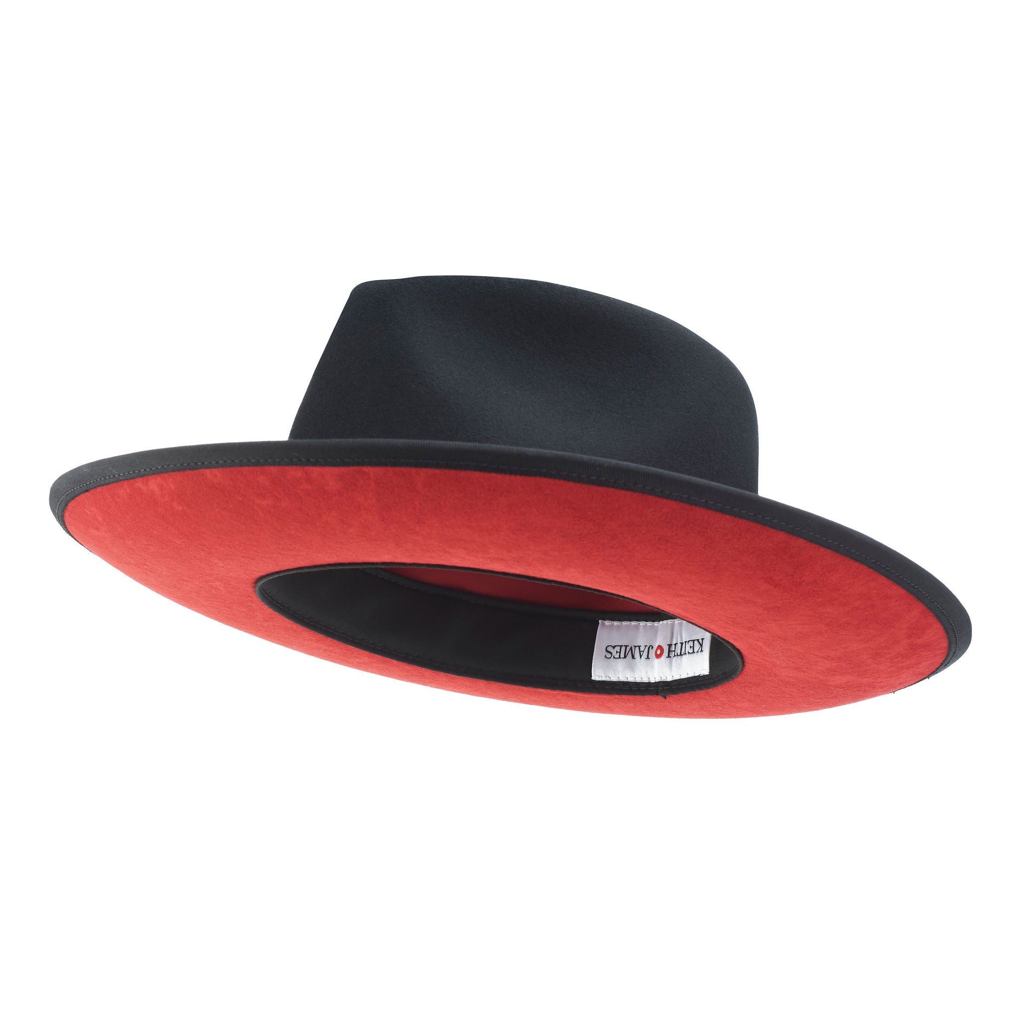 A classic black hat with a red bottom brim and a signature logo pin on the side.