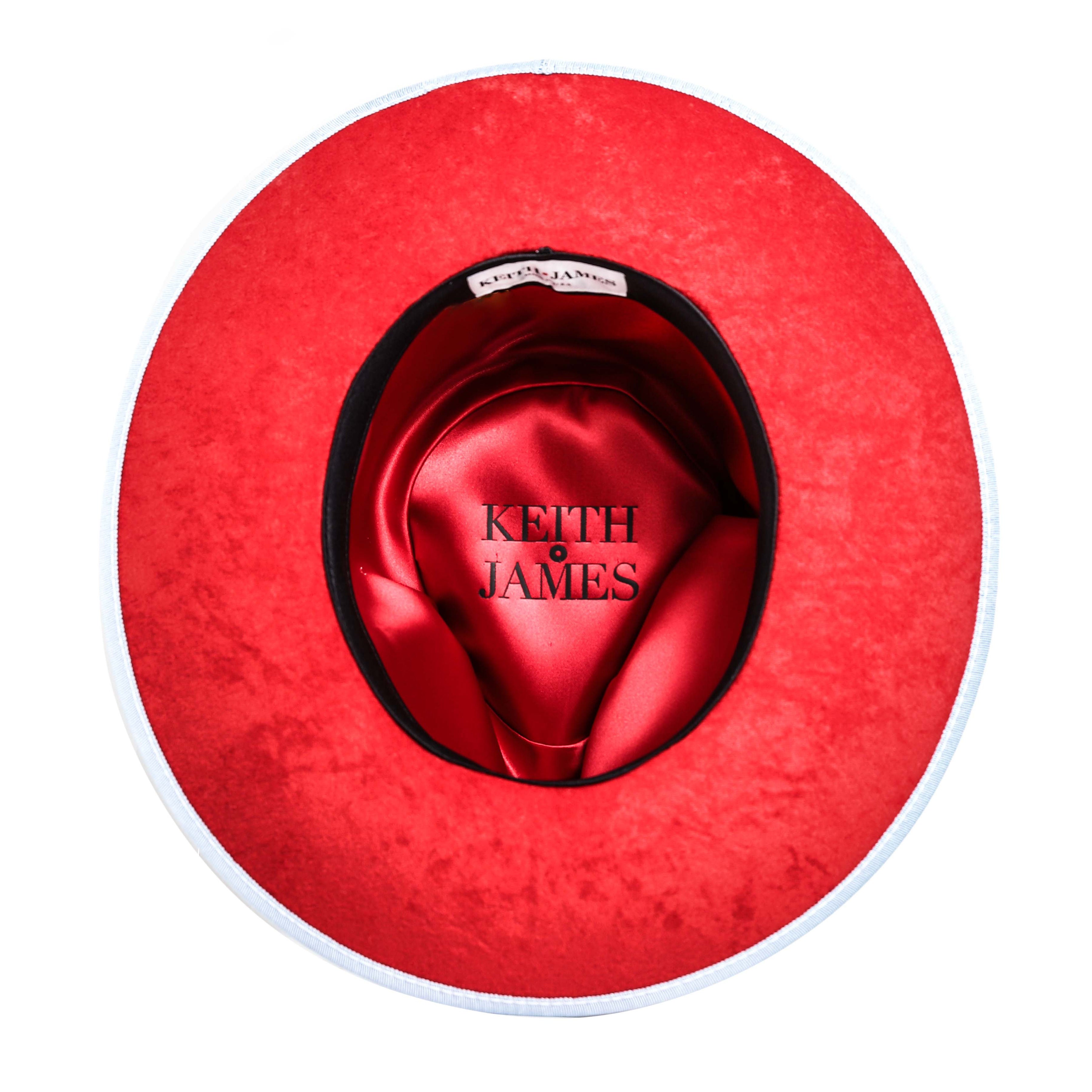 A swirl blue hat with a wide brim and a red bottom, featuring a classic ribbon and bow with a pin, made in the USA.