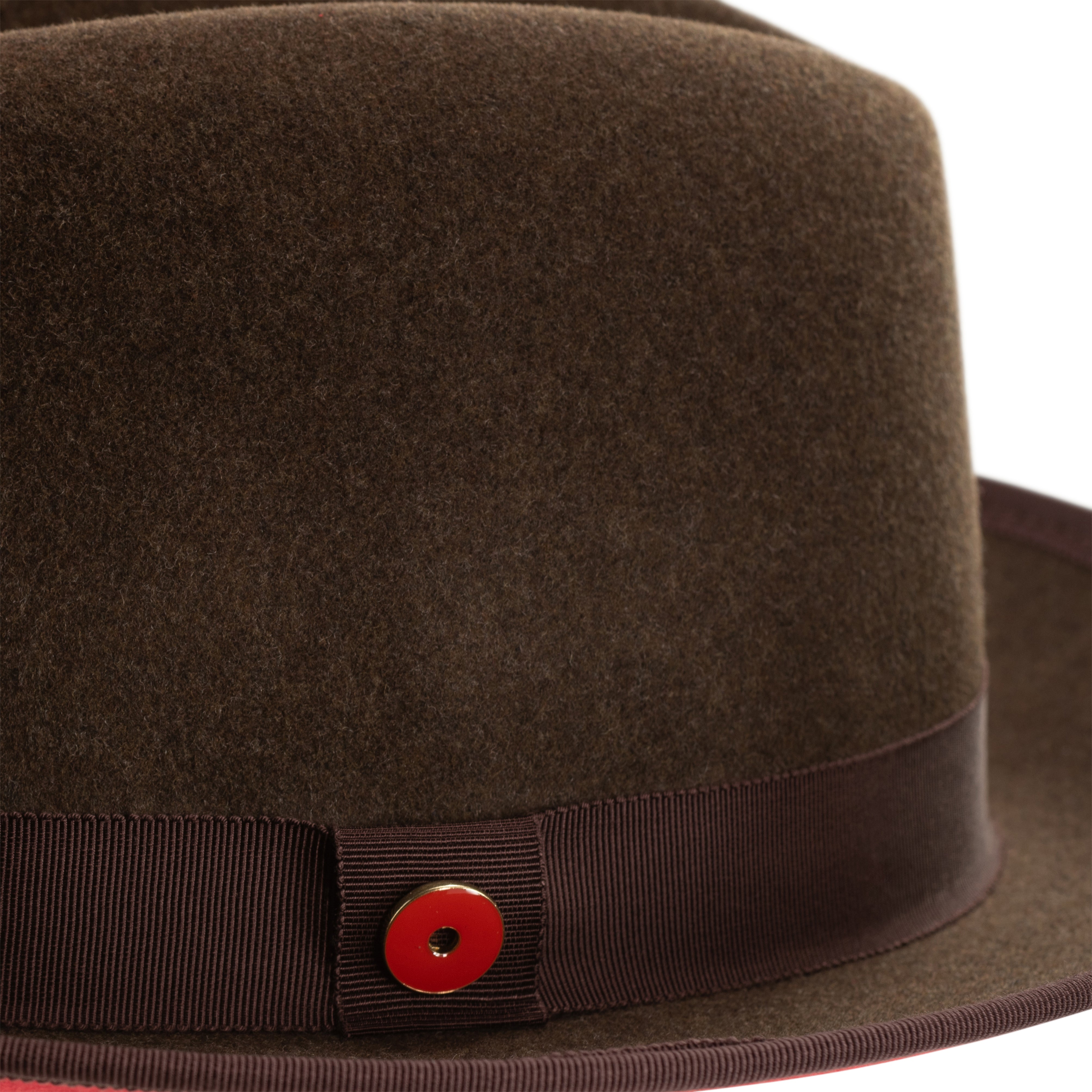 A cocoa brown classic center-creased fedora with a 2.5 inch curved brim and bound edge, featuring a red bottom brim and a signature logo pin.