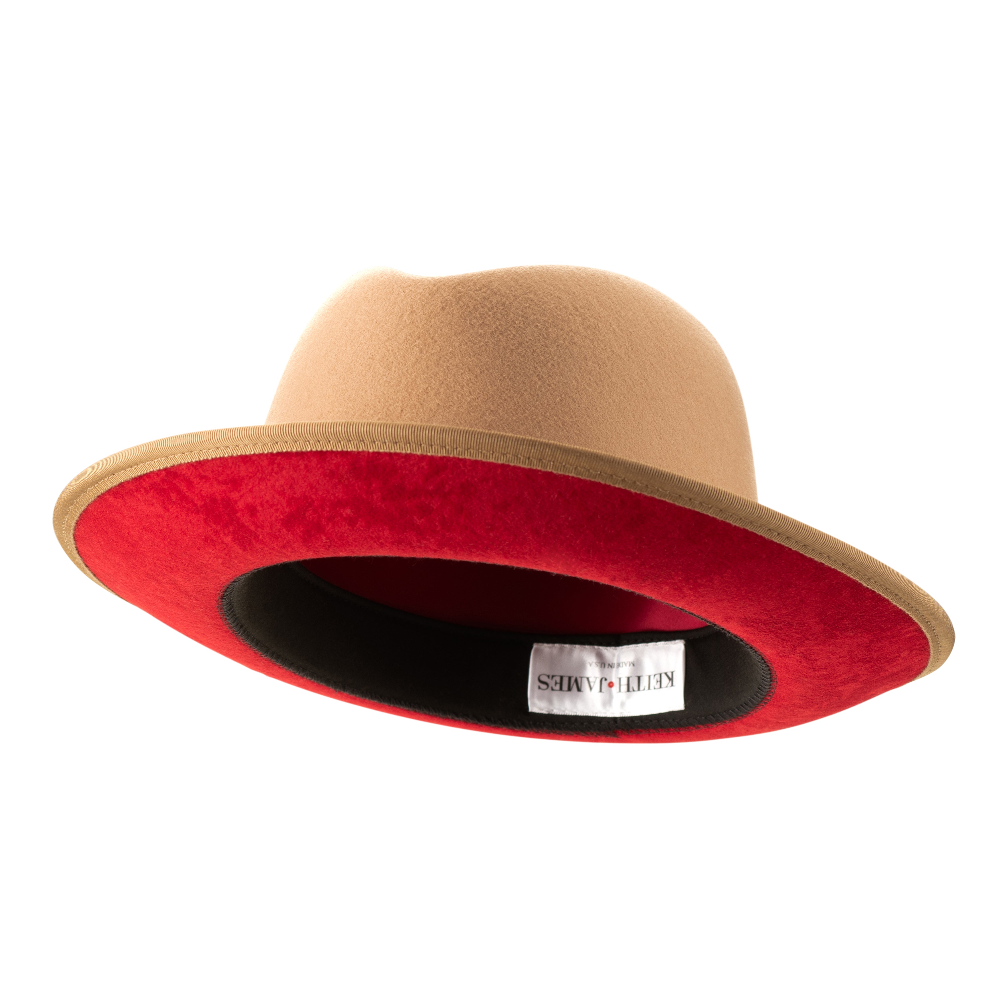 A golden honey colored fedora with a red ribbon trim and a red bottom brim, featuring a signature logo pin.