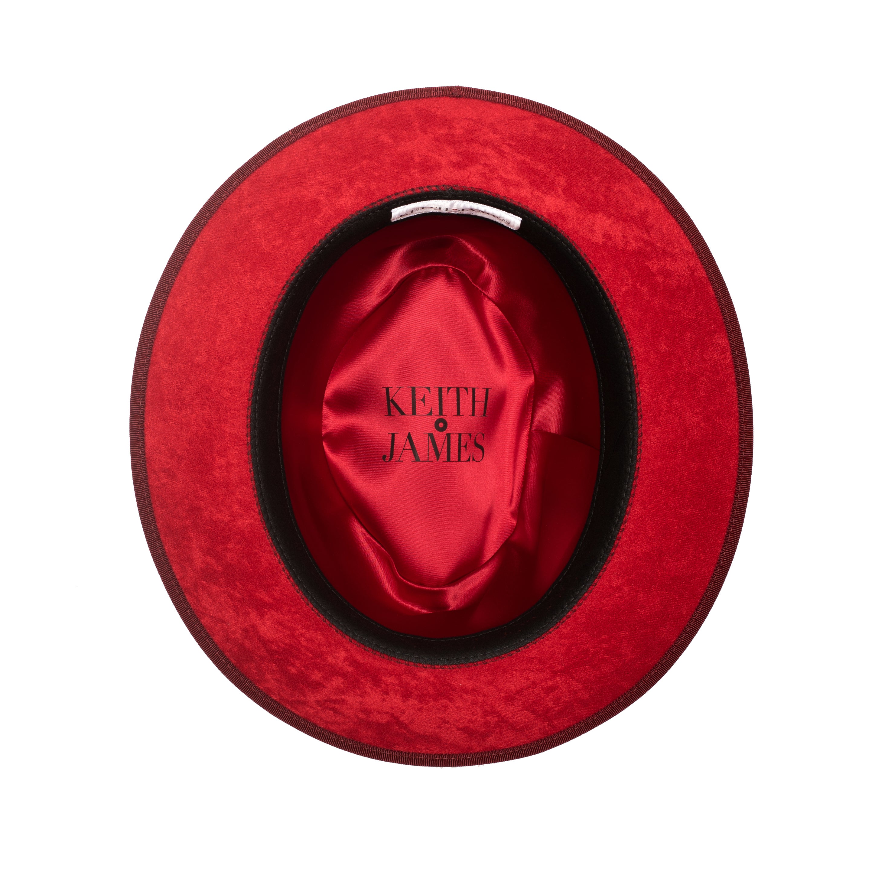 A classic center-creased fedora hat in old maroon color with a 2.5 inch curved brim, classic ribbon trim, a signature logo pin, and a red bottom brim.