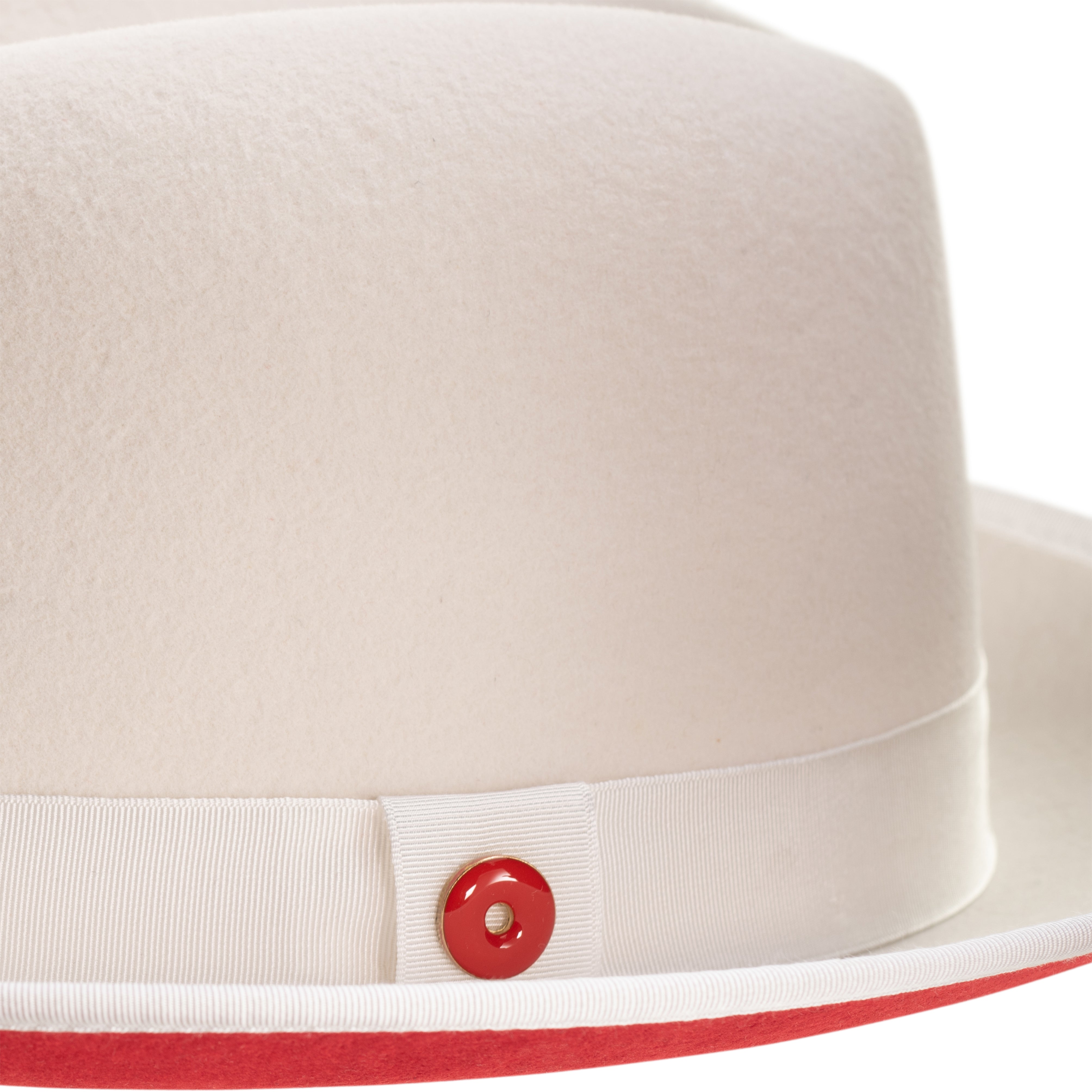A snow white fedora hat with a red bottom brim and a signature logo pin.