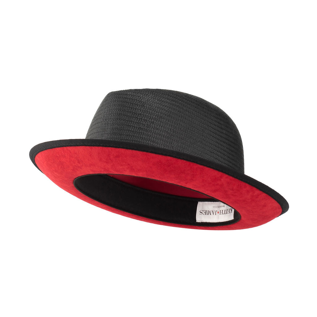A Jet Black straw fedora with a red under brim and a signature logo pin on the side.