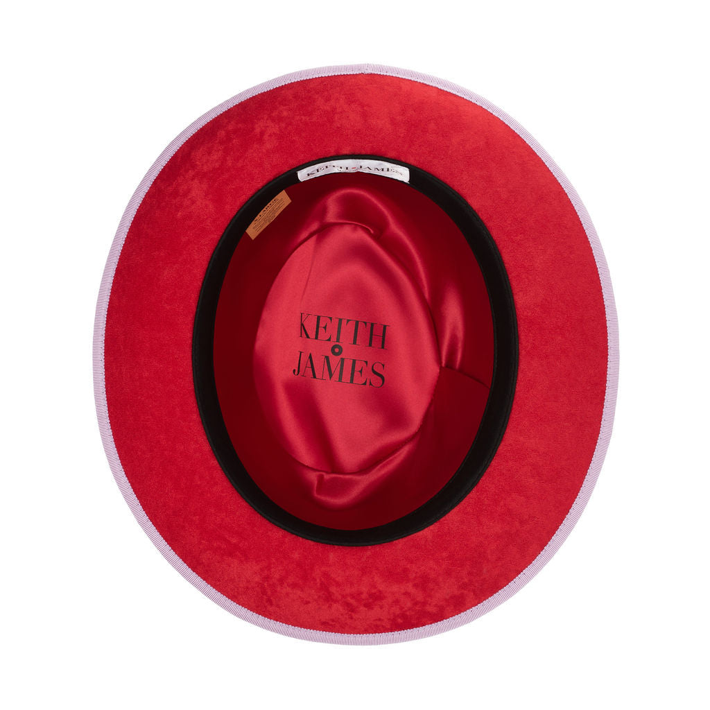 A purple classic center-creased fedora with a 2.5 inch curved brim, featuring a red bottom brim and a signature logo pin.