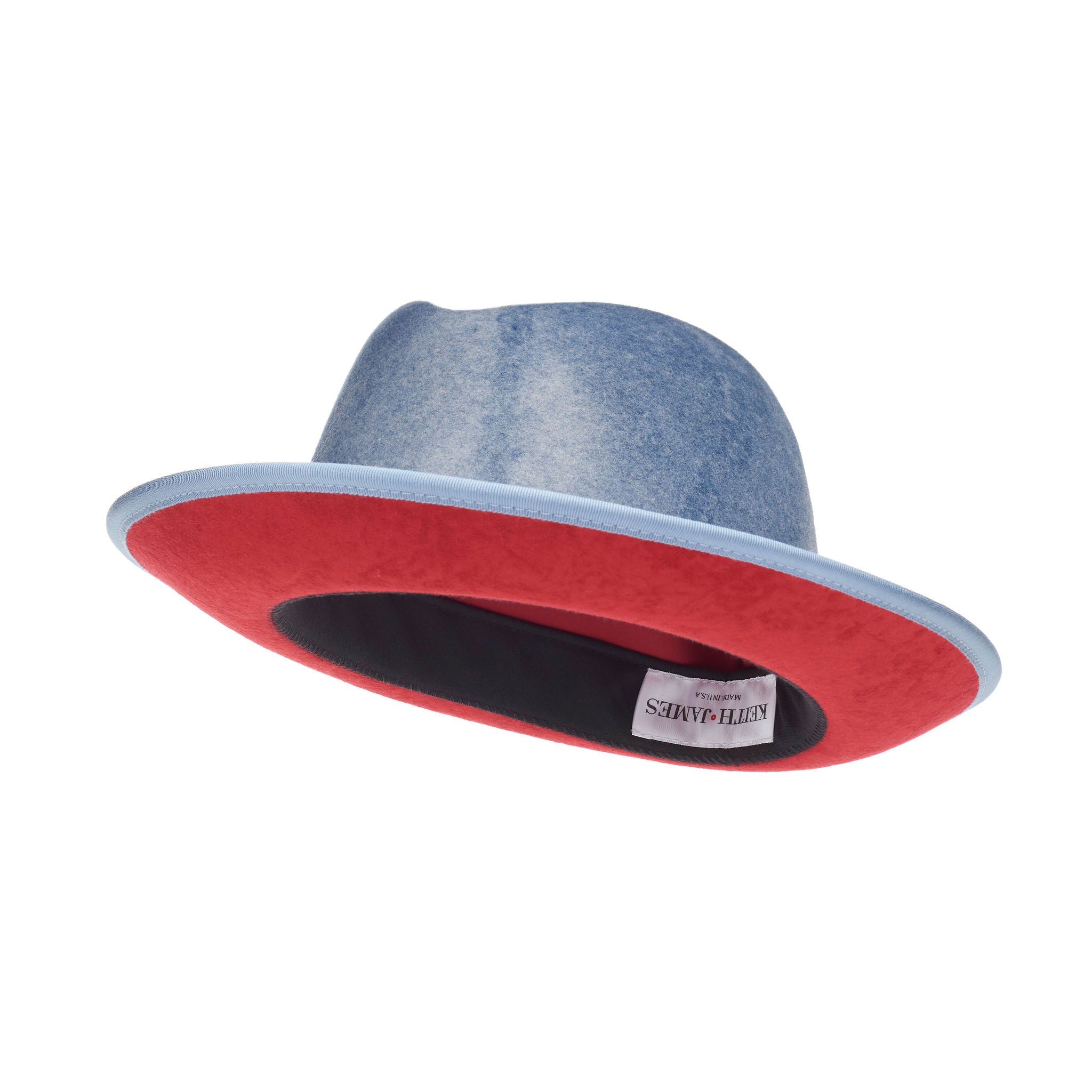 A blue fedora with a red bottom brim and a signature logo pin.