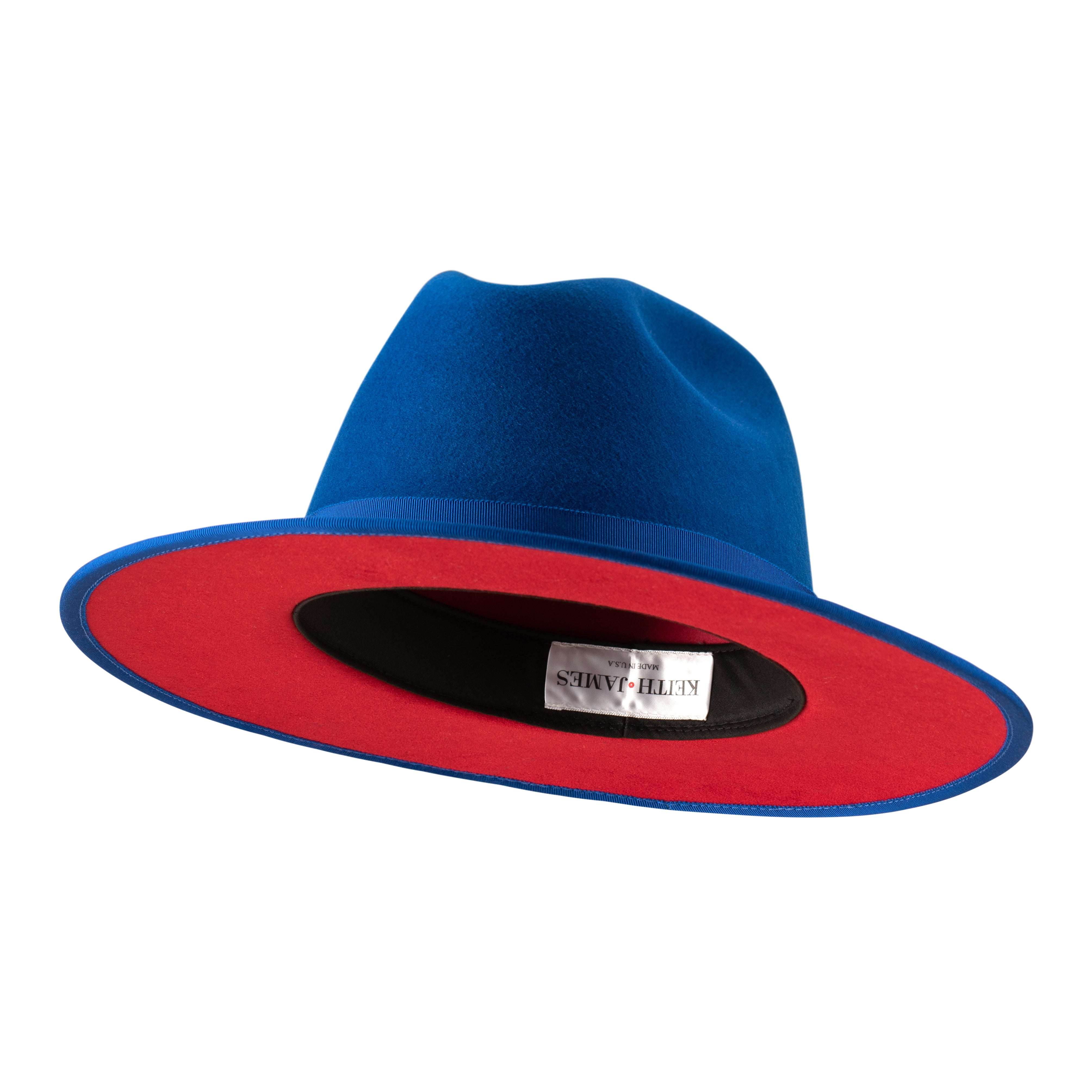 A true blue fedora hat with a pinched crown, flat brim, and bound edge. It includes a classic ribbon trim, a signature logo pin, and a red bottom brim.