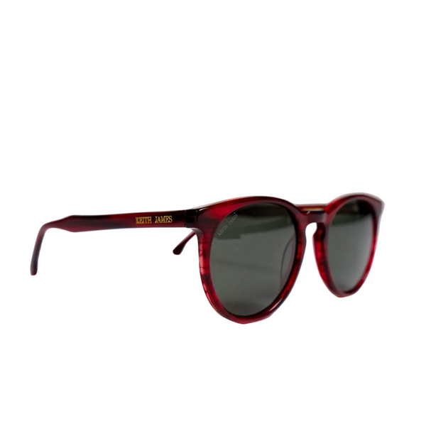 A pair of Havana red sunglasses with dark grey polarized mineral glass lenses, keyhole bridge, and logo engraved on the temple.